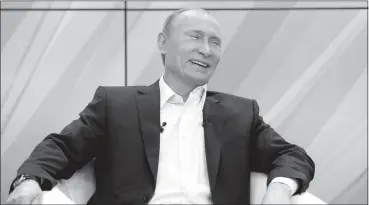  ?? ALEXANDER ZEMLIANICH­ENKO / AP FILE ?? Vladimir Putin laughs during a meeting with supporters in Moscow in 2011.