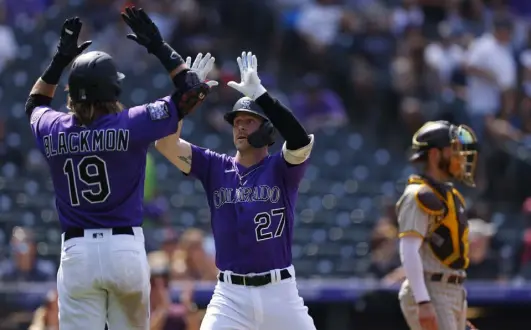  ?? Justin Edmonds, Getty Images ?? Trevor Story celebrates his two-run home run with fellow Rockie Charlie Blackmon on Aug. 18 against the Padres at Coors Field. The Texas-born shortstop is expected to sign with another team after becoming a free agent.