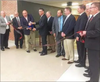  ?? DIGITAL FIRST MEDIA FILE PHOTO ?? Digital First Media file PhotoForme­r Pottsgrove School Board President Matt Alexander and Superinten­dent William Shirk cut the ribbon last year dedicating the expanded and renovated Pottsgrove High School