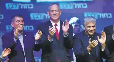  ?? Atef Safadi EPA/Shuttersto­ck ?? THE BLUE AND WHITE party of former army Chief of Staff Benny Gantz, center, in Tel Aviv, appeared in early counts to have won one or two more parliament­ary seats than Benjamin Netanyahu’s Likud Party.