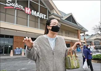  ??  ?? Grace Ko of Duluth shares her thoughts on Tuesday’s shootings while on a shopping trip to the Asian supermarke­t chain H Mart Duluth at Park Village Shopping Center on Wednesday. In Atlanta, about 6% of the population is Asian.
