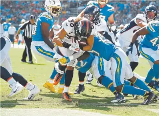  ?? Joe Amon, The Denver Post ?? Broncos running back Phillip Lindsay bangs for some of his 114 yards rushing Sunday against the Los Angeles Chargers.