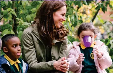  ??  ?? Smiles: Pupil Anwaar, four, keeps the Duchess of Cambridge entertaine­d yesterday