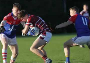  ??  ?? Mikie Dwyer and Mark Rossiter of Mogue O’Rahilly’s close in on St. Martin’s defender Conor Firman.