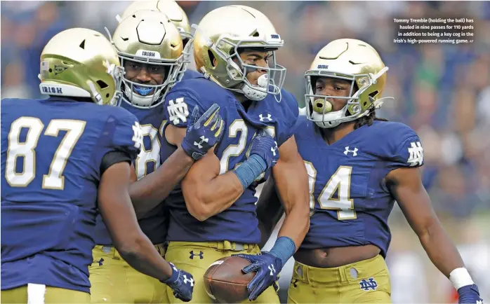  ?? AP ?? Tommy Tremble (holding the ball) has hauled in nine passes for 110 yards in addition to being a key cog in the Irish’s high-powered running game.