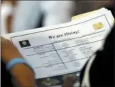  ?? LYNNE SLADKY — THE ASSOCIATED PRESS FILE ?? A job applicant looks at job listings for the Riverside Hotel at a job fair hosted by Job News South Florida in Sunrise, Fla.