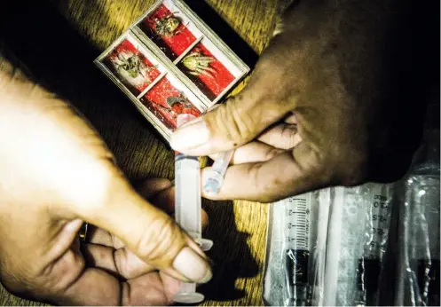  ?? SUNSTAR FOTOS / ALEX BADAYOS ?? FEEDING, FIGHTING. Before a fight in the “ruedahan” (above), some spider-fighting enthusiast­s feed their fighters (with the use of a syringe) a mix of energy drinks and pulverized vitamins.