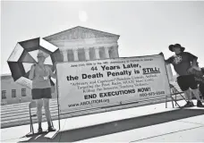  ?? MANDEL NGAN, AFP/GETTY IMAGES ?? Activists protest the death penalty June 29, a year after the Supreme Court upheld the use of a lethal injection method.