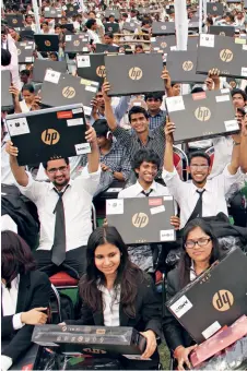  ??  ?? LAPTOP NATION Many politician­s have used the distributi­on of free laptops to students as an investment in their own political future. Seen here, students in Lucknow