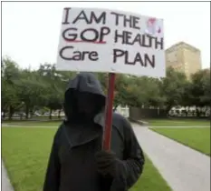  ?? MAX FAULKNER — STAR-TELEGRAM VIA AP ?? Cary Clark, dressed as the Grim Reaper, protest during a rally at Burnett Park in Fort Worth, Texas, Wednesday. Democratic nominee for Texas Attorney General Justin Nelson hosted the Fort Worth Rally for Preexistin­g Coverage Protection.