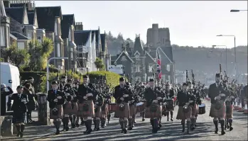  ??  ?? Oban Pipe Band joined forces with Oban High School Pipe Band to lead the way to the war memorial in Oban on Sunday morning.