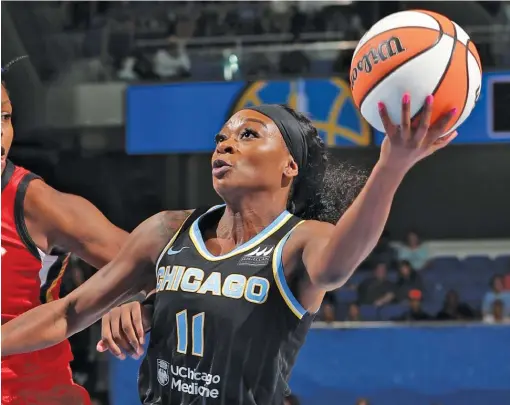  ?? GETTY IMAGES. ?? The Sky’s Dana Evans drives the lane for a layup Thursday night at Wintrust Arena. The Sky fell two games behind the Sparks for the last playoff spot.