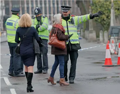  ?? AP ?? Police direct pedestrian­s around a cordon in place following Wednesday’s terror attack, in London, on Thursday. —