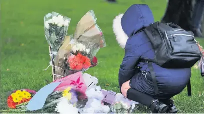  ??  ?? ●●A youngster reading some of the tributes to Marianne left at the scene of the tragedy last week