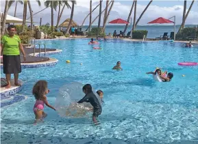  ?? Photo: Charles Chambers ?? Shangri-La’s swimming pool with locals enjoying the break on July 11.