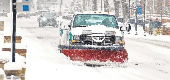  ?? PHOTOS BY JOSHUA MCKERROW/CAPITAL GAZETTE ?? An Annapolis snow plow clears Compromise Street Sunday morning.