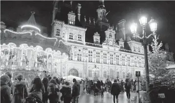  ?? LEWISJOLY/AP ?? The townhall in Paris is lit green Saturday to celebrate the fifth anniversar­y of the Paris climate accord.