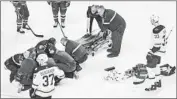  ?? Graham Hughes Associated Press ?? PHILLIP DANAULT is attended to after being hit in the head with a shot by Zdeno Chara (33).