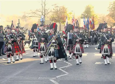  ??  ?? Tay Street in Perth resounds with the skirl of pipes.