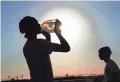  ?? MICHAEL CHOW/THE REPUBLIC FILE ?? Mason Williams drinks water during a break from football practice July 13 at Eastmark High School in Mesa. Arizona in 2020 saw its second hottest and second driest year on record.