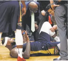  ?? Gerald Herbert / Associated Press ?? New Orleans’ DeMarcus Cousins lies on the court after hurting his Achilles. The injury ended his season.