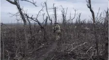  ?? IRYNA RYBAKOVA THE ASSOCIATED PRESS ?? A Ukrainian soldier walks the front line Wednesday near Klishchyiv­ka, Donetsk region, eastern Ukraine. Soldiers have been rationing their munitions as the U.S. Congress has delayed passing a military aid bill.