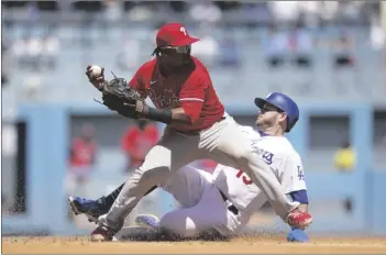  ?? AP PHOTO/ASHLEY LANDIS ?? Philadelph­ia Phillies second baseman Jean Segura (2) throws to first for a double play during the fourth inning of a baseball game against the Los Angeles Dodgers in Los Angeles, on Sunday.