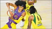  ?? Julio Aguilar Getty Images ?? THE SPARKS’ Brittney Sykes looks to pass around Seattle’s Natasha Howard in the first half Saturday.