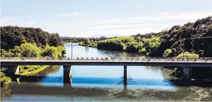  ?? PHOTO: SUPPLIED ?? Scenic splendour . . . Riders pass over the Waiau River bridge at Clifton on stage two of the Tour of Southland yesterday. The stage was won by Corbin Strong.