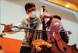  ?? Justin Katigbak For The Times ?? ANGELO PANCHI, from Venezuela, practices during a break in rehearsals. He is one of 106 young musicians from around the world in the Encuentros program.