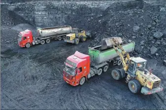  ?? WANG ZHENG / FOR CHINA DAILY ?? Trucks are loaded with coal at a coal mine in the Inner Mongolia autonomous region on Tuesday.