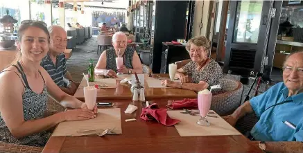  ??  ?? Enjoying cold drinks in Bali. Debra, left, says planning the travel and accommodat­ion was more time-consuming than she had thought, but "well worth the effort to get right".