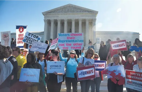  ?? OLIVIER DOULIERY / GETTY IMAGES ?? Demonstrat­ors gather outside the United States Supreme Court during oral arguments in Gill v. Whitford to call for an end to partisan gerrymande­ring on Oct. 3, in Washington, D.C. The Supreme Court on Monday sent that case back to a lower court after deciding that Wisconsin Democrats didn’t have “standing” to bring the case. Democrats now get a chance to try again.