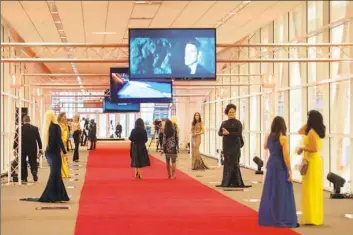  ?? Stephanie Strasburg/Pittsburgh Post-Gazette ?? The red carpet leading to the Pittsburgh Film Office's Lights! Glamour! Action Oscar party in 2017 at the David L. Lawrence Convention Center. For 2018, the Pittsburgh Film Office is inviting designers to create red carpet looks that incorporat­e the...