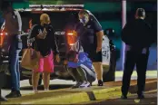  ?? ARMANDO L. SANCHEZ — CHICAGO TRIBUNE FILE ?? A woman kneels on the ground outside the University of Chicago Medicine’s Comer Children’s Hospital where a 8-year-old girl was taken after being killed in a shooting that wounded three others in Chicago.