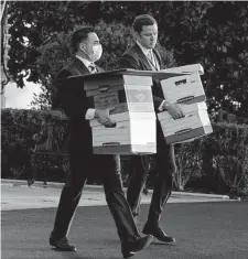  ?? ?? Aides move boxes out of the White House as President Donald Trump prepares to board Marine One on his last day.