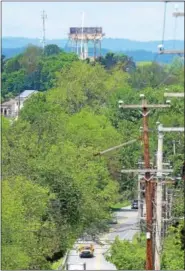  ?? PETE BANNAN — DIGITAL FIRST MEDIA ?? The iconic water tank at the Pennhurst State Hospital property came down. It could be seen in the distance along Route 724 in Spring City.