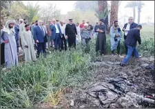  ??  ?? Egyptians and Luxor Governor Ezzat Saad (fourth left), inspect the scene of a balloon crash outside al-Dhabaa village, just west of the city of Luxor, 510 kms (320 miles) south of Cairo, Egypt, Feb 26. A hot air balloon flying over Egypt’s ancient city...