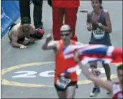  ?? CHARLES KRUPA — THE ASSOCIATED PRESS ?? Micah Herndon, of Tallmadge, Ohio, crawls to the finish line in the 123rd Boston Marathon on Monday in Boston.