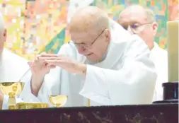  ?? JEFF VORVA/DAILY SOUTHTOWN ?? The Rev. Albert Adamich celebrates Mass on his 100th birthday Sunday at Most Holy Redeemer Church in Evergreen Park.