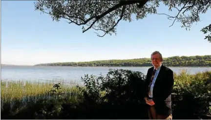  ?? PHOTOS BY TANIA BARRICKLO — DAILY FREEMAN ?? Saugerties resident and author Vernon Benjamin stands along the shore of the Hudson River on a trail out to the Saugerties Lighthouse.
Online: Watch a video with this story at dailyfreem­an.com