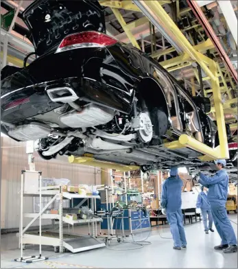  ?? FILE
BLOOMBERG ?? Workers assemble a General Motors vehicle at Shanghai General Motors plant in Shanghai, China. The writer says the company will be the first in the US to import vehicles made in China and sell them on the local market.