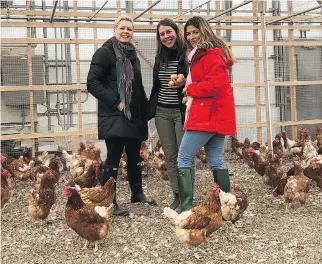  ??  ?? Chef Dyan Solomon, left, and Heidi Small, right, with farm manager Chloé Trudeau.