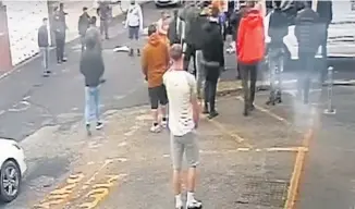  ??  ?? An image from video footage showing people looking on during the incident at Sadler Street Industrial Estate in Church. Right, police on the scene