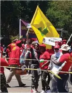  ?? (SAFI/Facebook) ?? AN EFF PROTESTER holds a Hezbollah flag at yesterday’s march against Israel outside its embassy in the South African capital.