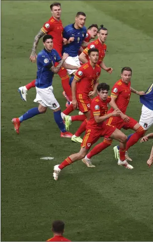  ??  ?? Matteo Pessina (front) scores to send the Italian players into rapturous celebratio­n (left)