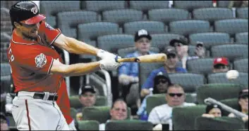  ?? John Amis The Associated Press ?? Nationals pitcher Max Scherzer connects for a pinch-hit single in the 14th inning of Washington’s 5-3 victory over the Braves on Saturday. He scored the go-ahead run.