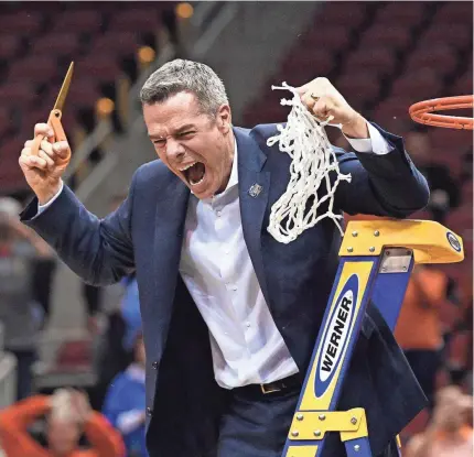  ?? JAMIE RHODES/USA TODAY SPORTS ?? Virginia head coach Tony Bennett reacts during the net-cutting ceremony after the championsh­ip victory against Purdue in the South Regional last weekend.