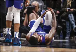  ?? RINGO H.W. CHIU — THE ASSOCIATED PRESS ?? Clippers forward Paul George, right, lies on the court after an injury during the second half against the Thunder on Tuesday in Los Angeles.