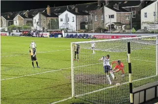  ?? CLIVE BRUNSKILL THE ASSOCIATED PRESS ?? Tottenham’s Carlos Vinicius scores past Marine’s goalkeeper Bayleigh Passant during an English FA Cup match at Rossett Park stadium in Crosby in northwest England on Sunday.